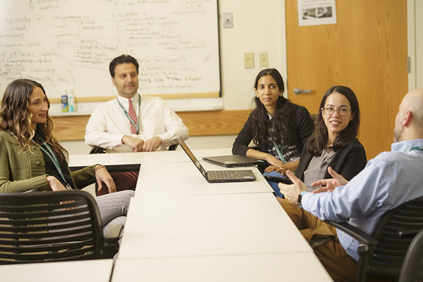 Providers have a conversation in a conference room