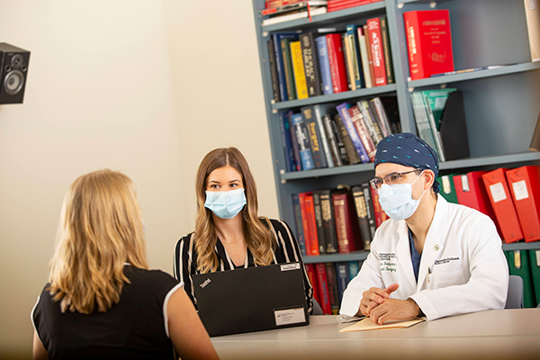 Providers having a conversation around a table