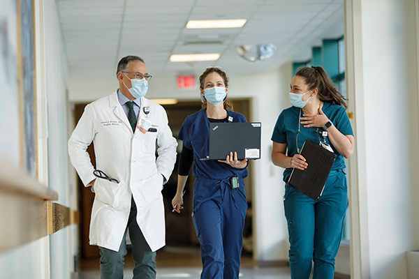 Providers walking down a hospital hallway