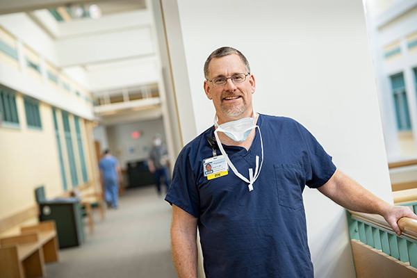 A smiling nurse standing in a hallway at Dartmouth Hitchcock Medical Center