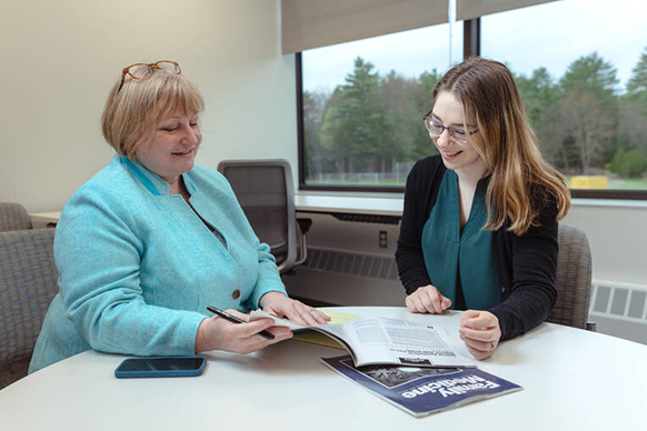 An instructor and a student sitting at a table