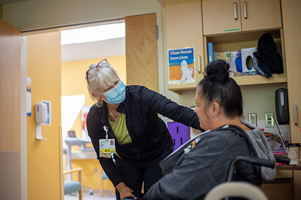 A Nurse speaking with a patient in a wheelchair at Mt. Ascutney Hospital and Health Center