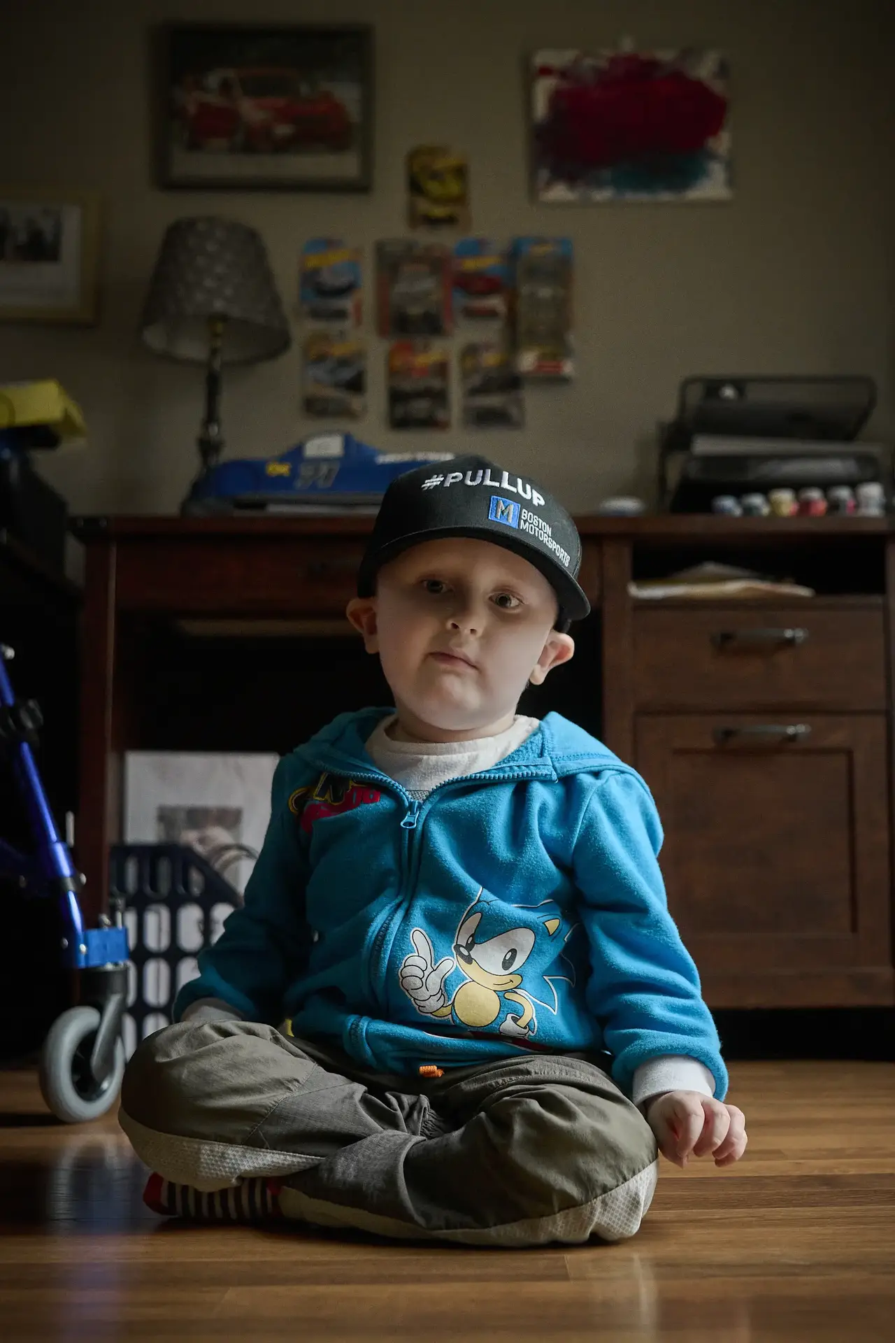 Patient Connor Ponce sitting cross legged on the floor