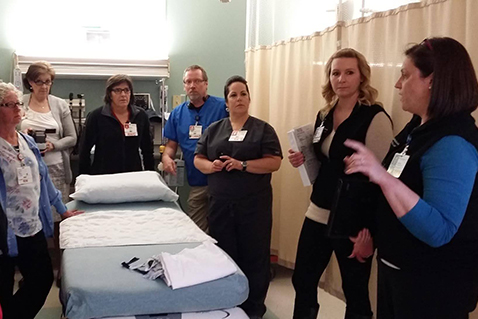 Nurses being instructed in a hospital room