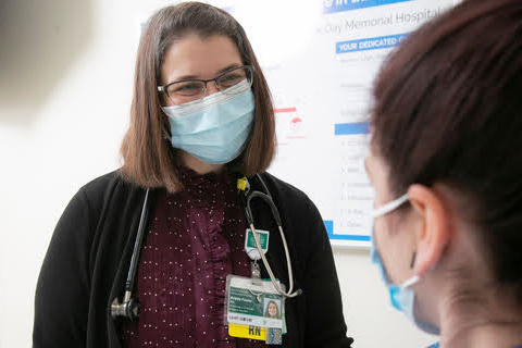 A nurse talking to another nurse