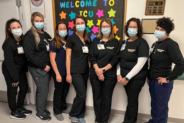 A group of nurses standing together in a hallway