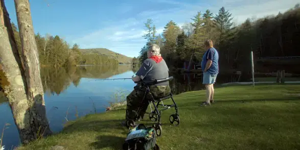 Patient Kathy Ryan and a friend seen fishing at a body of water