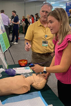 A student learning how to use a patient simulator