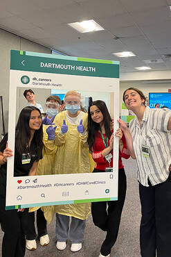 Intern students posing in a Dartmouth Health photo frame