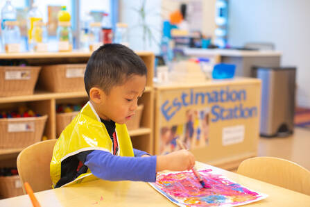 Preschooler at table with game