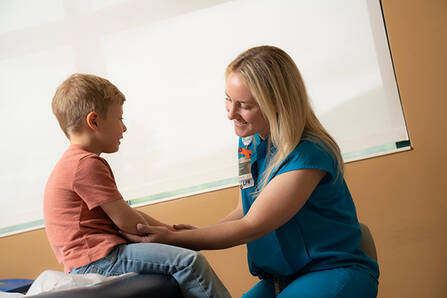 An LNA examining a child