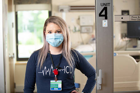 A nursing student standing in a clinic doorway