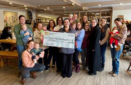 HFCU staff and Baby Café participants with donation check