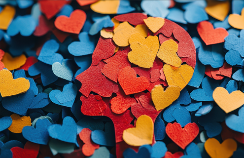 A colorful silhouette of a face made of hearts and other shapes