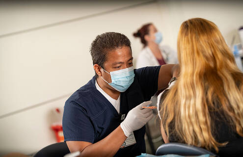 Clinician giving a patient a vaccination