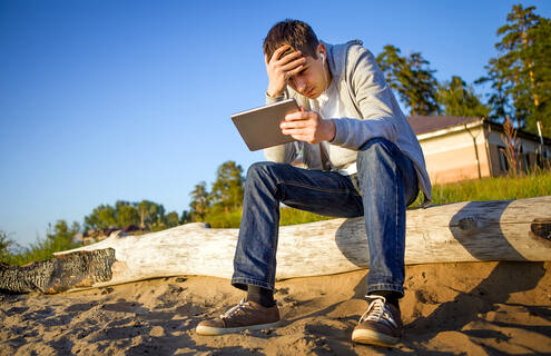 Man sitting outside looking stressed
