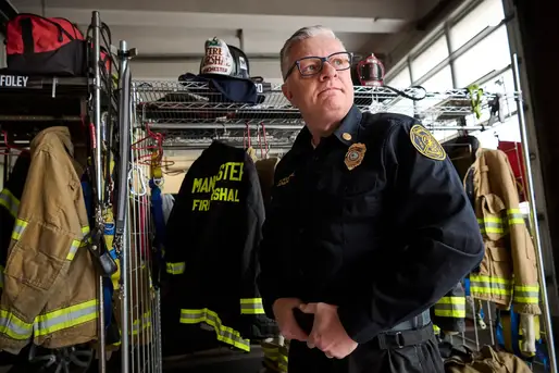 Firefighter Peter Lennon standing in the fire station