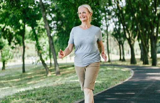 Middle aged woman walking on an outdoor path