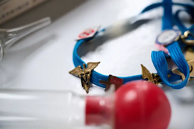 a lanyard with badges lying on a table