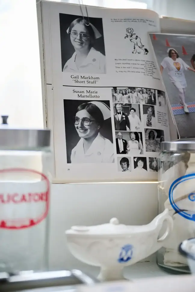 a school yearbook showing Nurse Susan Januszewski is seen standing by a table